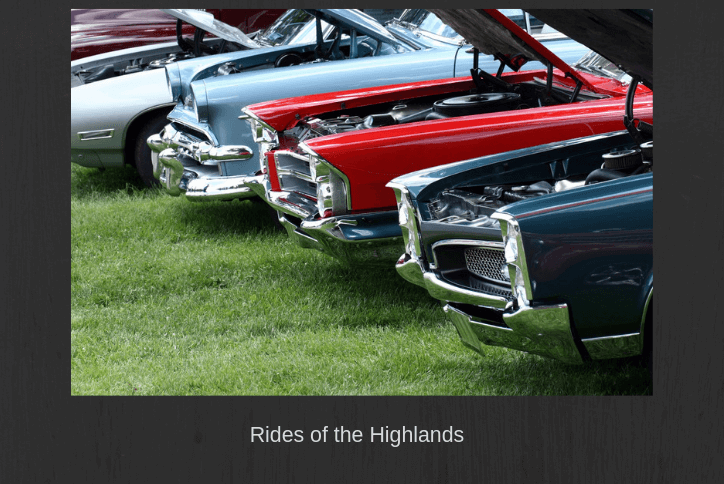 Row of antique cars with open hood.