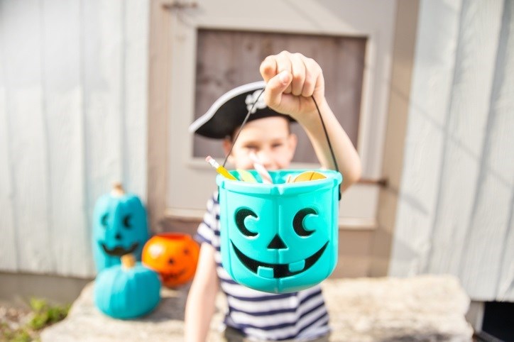 Young boy with a full teal pumpkin.