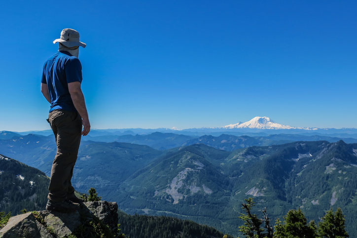 Hiking looking at Mount Rainier in the distance.