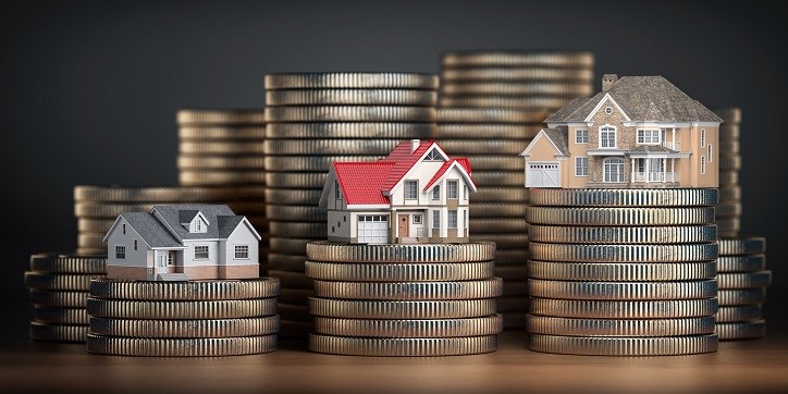 Houses perched on what appears to be stacks of quarters.
