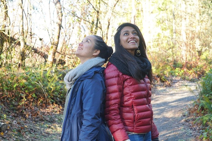 Two women looking up in amazement at the Tehaleh trails.