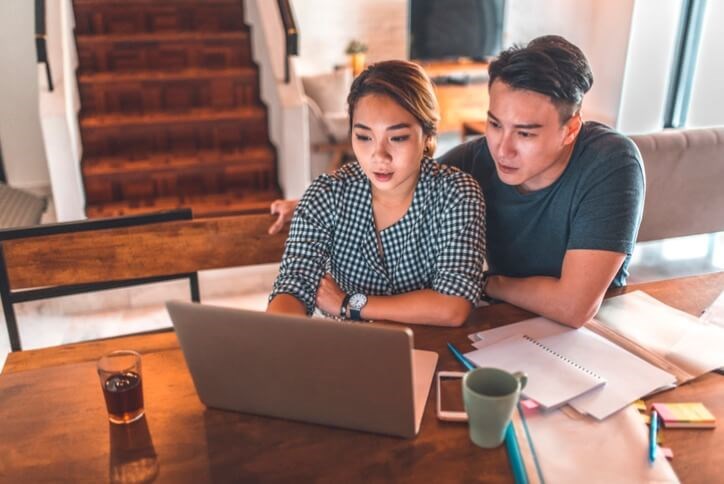 A couple crunching numbers on their computer