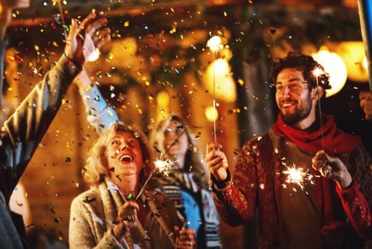 Family and friends celebrating outside with sparklers