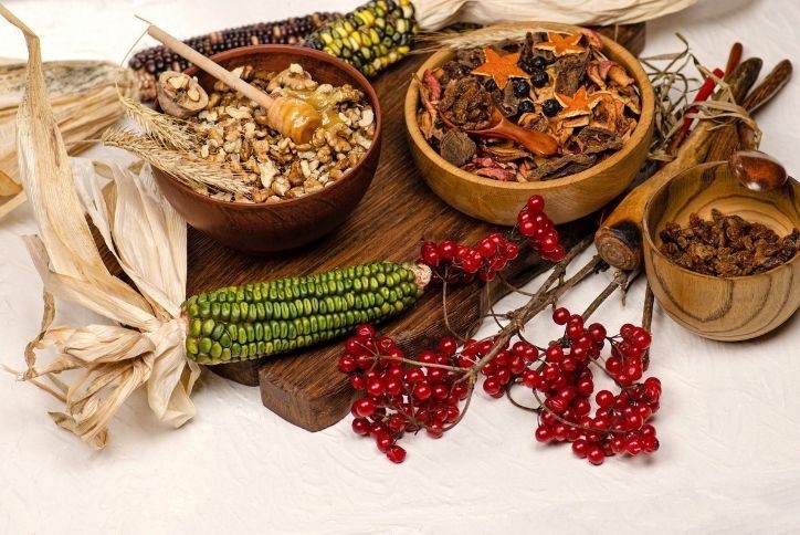 Green corn, fall spices and honey oats on table.