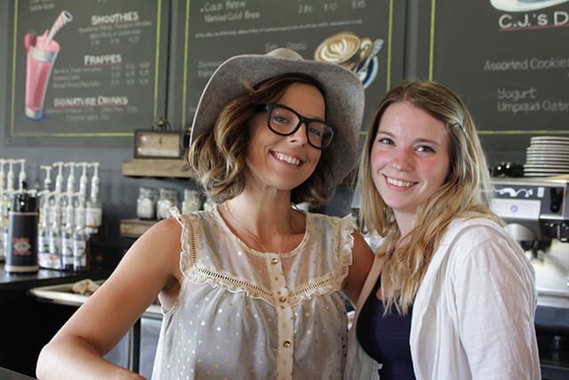 Two women smiling in Tehaleh's cafe.