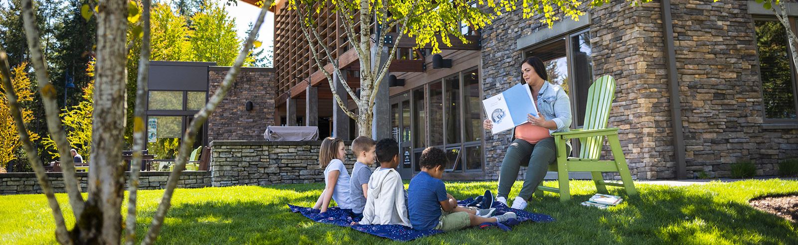 Woman reading to children in front of The Post