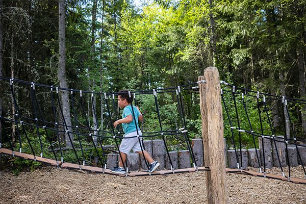 Boy playing in a wooded playground