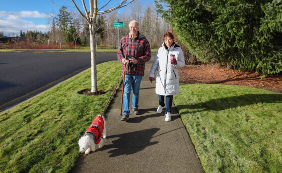 Tehaleh community residents walking with their dog along the trails in Bonney Lake, WA