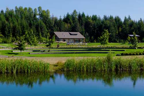 Residents jogging and cycling around a pond in Discovery Park in Tehaleh.