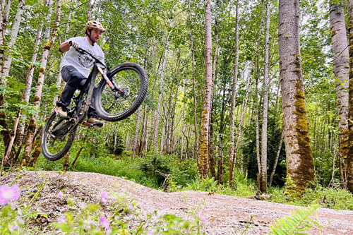 A mountain biker in mid-air on one of Treks many mountain bike trails.
