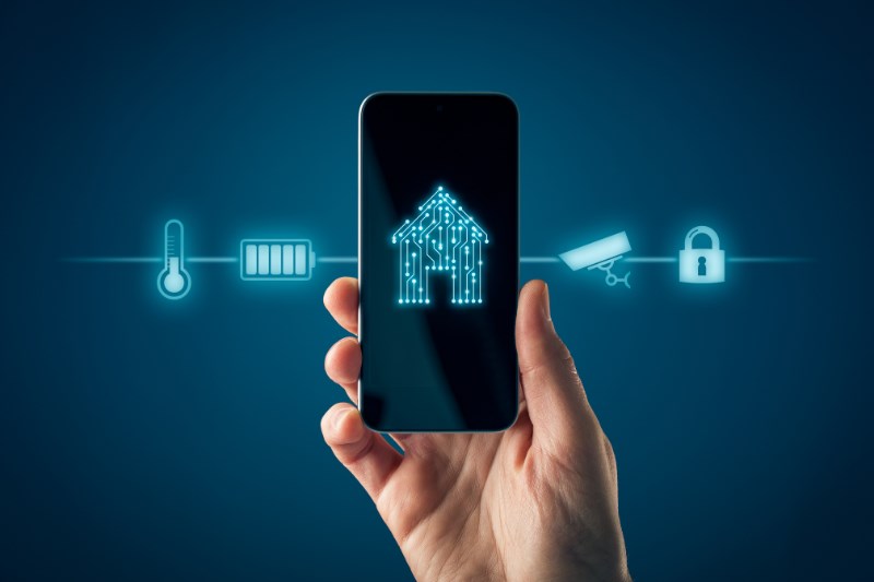 a hand holds up a smart phone that displays the many different ways your phone can be used to control the lights and appliances in your home.