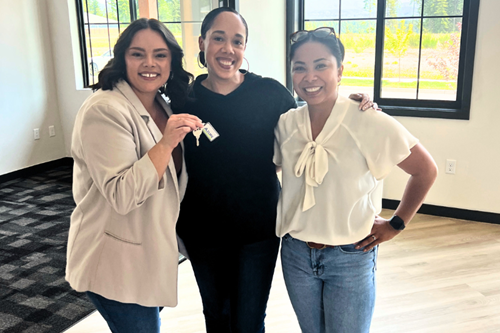 The Tehaleh Marketing team pose with their new office keys inside the new Welcome Center.