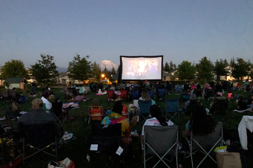Residents gathered in Discovery Park to watch a movie as the sun goes down